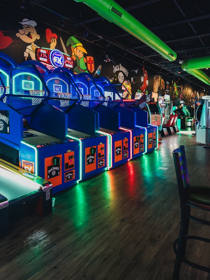 Home Colorful indoor arcade featuring basketball games and vivid neon lighting.